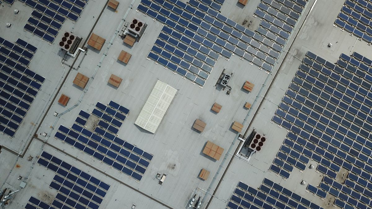 Aerial view of a rooftop solar panel installation on a residential home