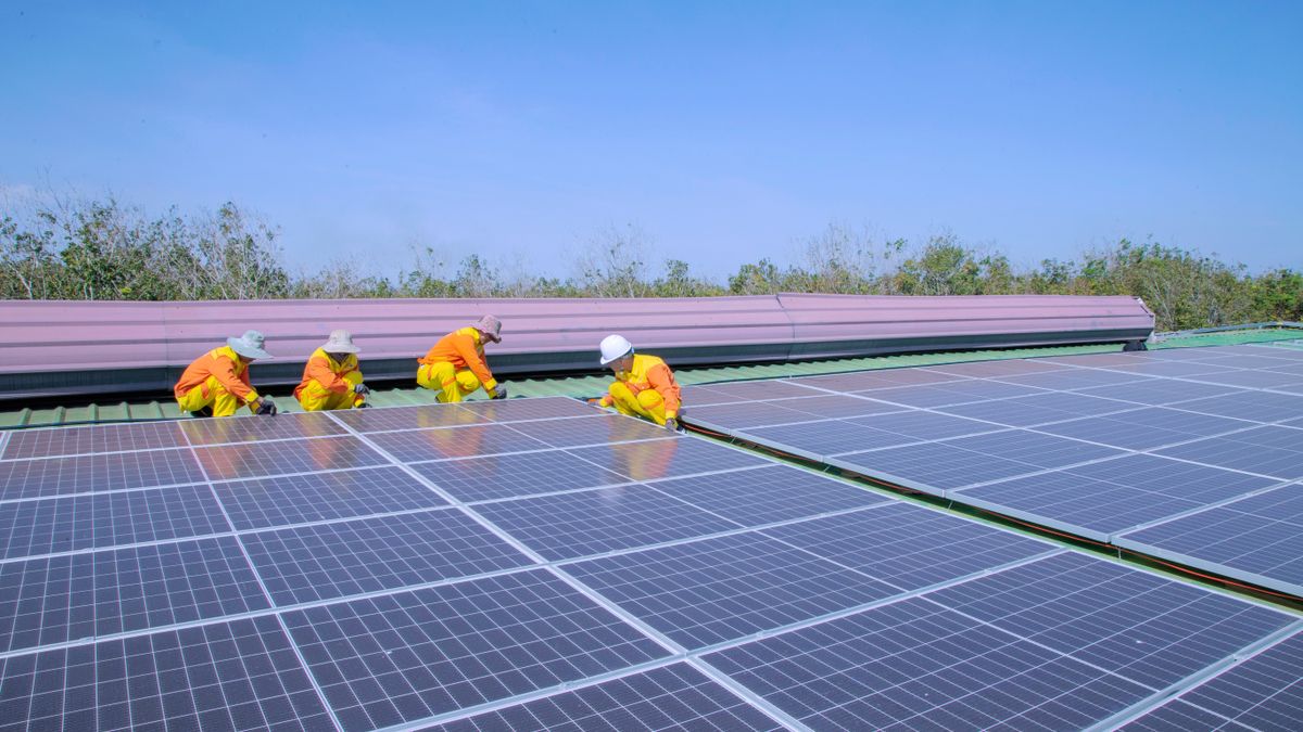 Solar technicians installing panels on a rooftop